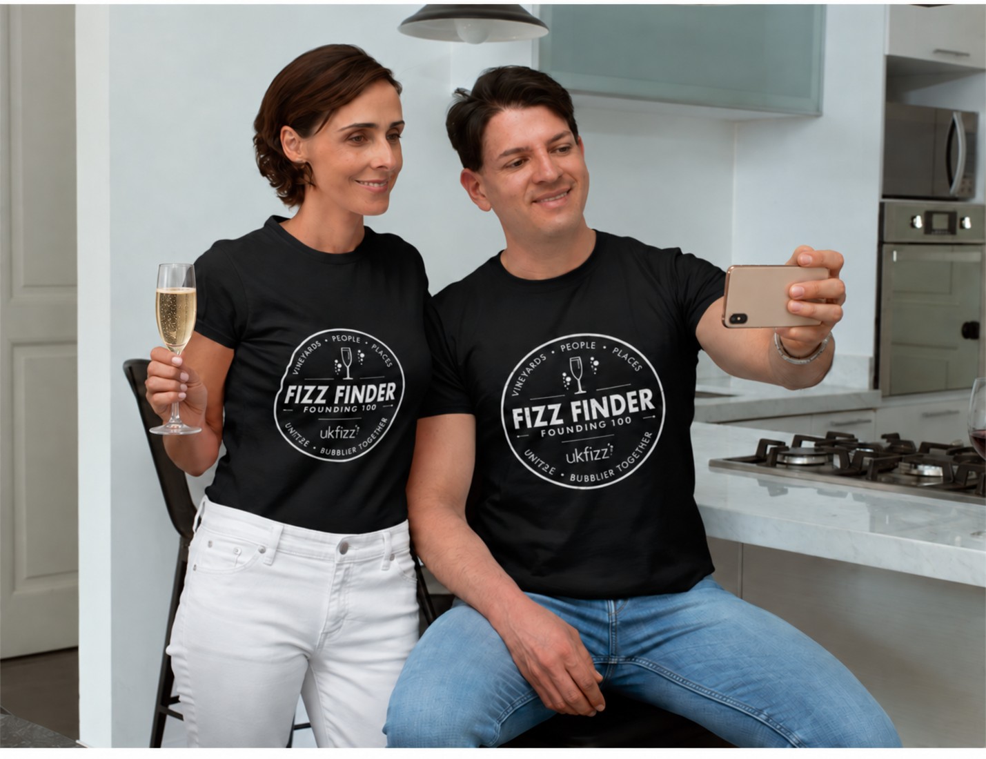 Two adults wearing Founding 100 Fizz Finder T-shirts
