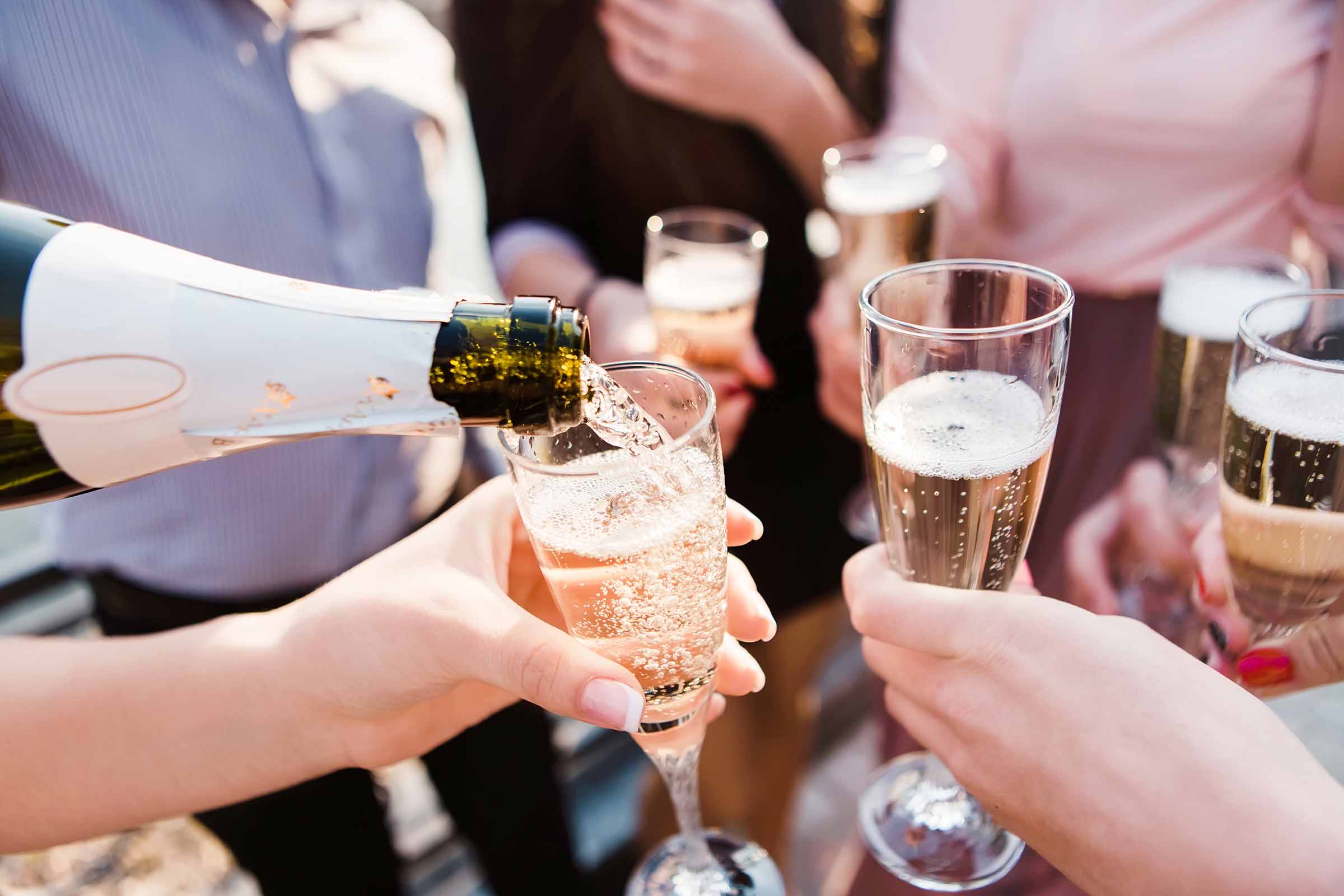 Friends raising glasses of British sparkling wine