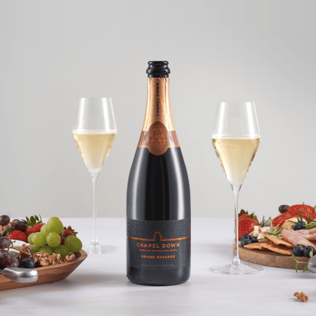 Chapel Down Grand Reserve 2020 — single bottle with glasses and food