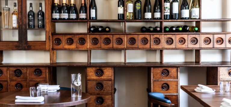Wine shelving and dining tables inside Hide and Fox, Saltwood