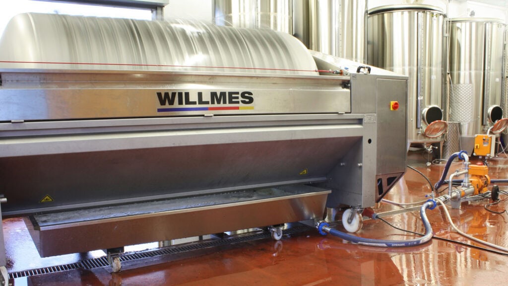 Grape press and stainless-steel tanks inside Stopham winery